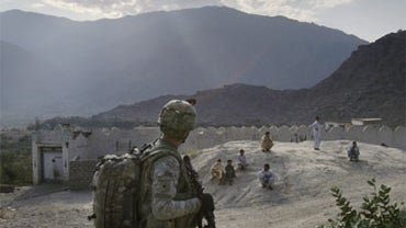 U.S. soldiers from the 2nd Battalion, 12th Infantry Regiment, 4th Brigade Combat Team, 4th Infantry Division patrol through a village in the Pech Valley of Afghanistan's Kunar province Friday, Nov. 6, 2009. 
