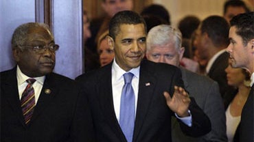 President Obama waves as he walks out of the Cannon Caucus Room with Majority Whip James Clyburn, D-S.C., left, after meeting with House Democrats about health care on Capitol Hill in Washington, Saturday, Nov. 7, 2009.(AP Photo/Alex Brandon) 