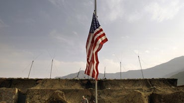 A U.S. flag flies half-mast, in honor of the 13 dead and 30 wounded in the shooting rampage at Fort Hood Army post in central Texas, at an outpost for soldiers from the 2nd Battalion, 12th Infantry Regiment, 4th Brigade Combat Team, 4th Infantry Division  