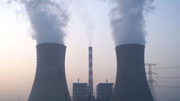 Smoke rises from cooling towers at a coal-fired power plant in Kaifeng, in central China's Henan province, Sunday, Nov. 1, 2009. 
