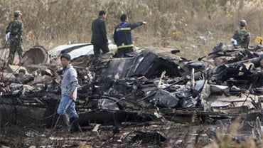 Emergency personnel work at the crash site of a cargo plane at Pudong International Airport in Shanghai, China, Saturday Nov. 28, 2009. 