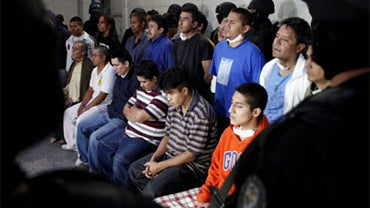 Suspect members of a gang that allegedly traffics in people are shown to the press in Mexico City, Thursday, Dec. 3, 2009. 