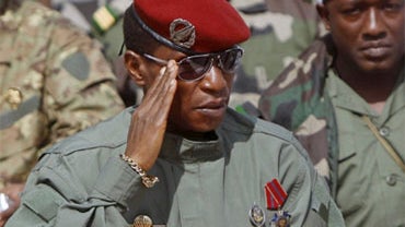 Guinea military leader Capt. Moussa Dadis Camara salutes next to his aide Abubakar "Toumba" Diakite during independence day celebrations in Conakry, Guinea in this photo taken Friday, Oct. 2, 2009. 