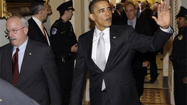 President Barack Obama waves as he leave the Senate Democratic caucus on Capitol Hill in Washington Sunday, Dec. 6, 2009. 