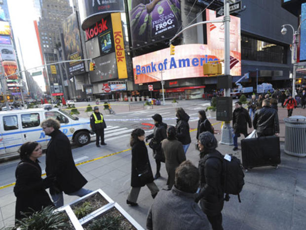 SLIDESHOW - Police officers guard a cordoned off area around the Marriot Marquis Hotel in Times Square where a shooting took place, Thursday, Dec.10, 2009, in New York. 
