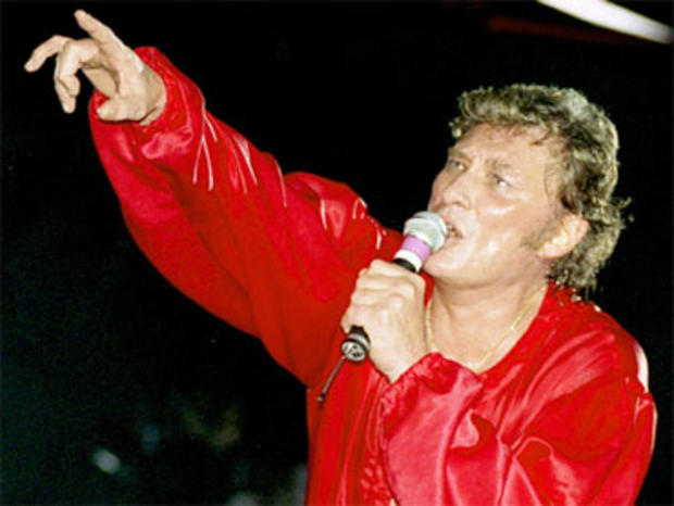 French rock star Johnny Hallyday performs during his 50th birthday concert at the Parc des Princes stadium in Paris, in this June 15, 1993 photo. 