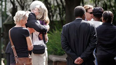 Friends and colleagues wait outside Lee Funeral Home in Nairobi, Kenya to attend funeral services 