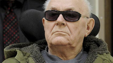 Accused former death camp guard John Demjanjuk is brought into a courtroom in Munich, southern Germany Tuesday, March 16, 2010.  