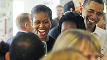First lady Michelle Obama and President Barack Obama wait in line to order at 12 Bones Smokehouse in Asheville, N.C., Friday, April 23, 2010. 