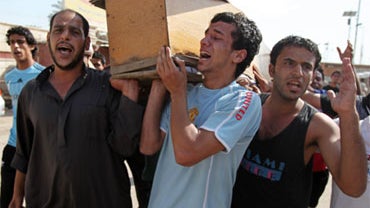Men carry the coffin of a relative killed in one of a series of bombs in the Shiite stronghold of Sadr City in Baghdad, Iraq, Friday, April 23, 2010. 
