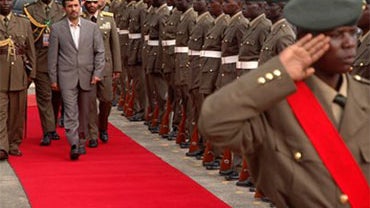 Iranian President Mahmoud Ahmadinejad inspects a guard of honor at Uganda's State House in Entebbe, at the end of the second day of his visit on Saturday April 24, 2010 to Uganda. 