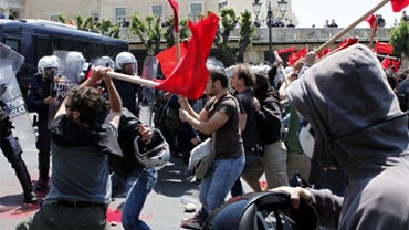 Protesters clash with riot police outside the Greek Parliament in Athens on Saturday May 1, 2010. 