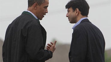 President Barack Obama is greeted by Louisiana Gov. Bobby Jindal, right, as he arrives at Louis Armstrong International New Orleans Airport en route to the Gulf Coast region where he will visit damage caused by the BP oil well spill, Sunday, May 2, 2010.  