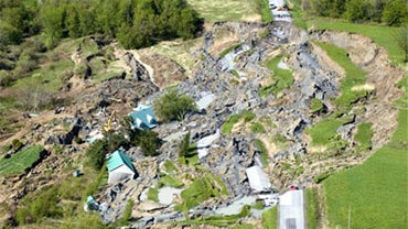 A landslide in Saint-Jude, Quebec is shown from the air on Tuesday, May 11, 2010. Four people, including two children, are missing after a sinkhole triggered by a landslide swallowed their house northeast of Montreal. (AP Photo/The Canadian Press, Graham  