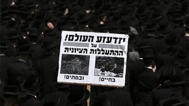 Ultra-Orthodox men protest against the relocation of graves near Barzilai hospital in Ashkelon, in Jerusalem, Thursday, May 20, 2010. Israeli antiquities authorities on Sunday relocated ancient graves, they say belong to Christians or pagans, in order to  