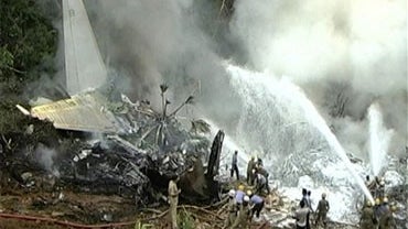In this frame grab made off TV9 video, firefighters try to douse flames on an Air India plane that crashed in Mangalore, in the southern Indian state of Karnataka, Saturday, May 22, 2010. The plane arriving from Dubai crashed Saturday morning after it ove 