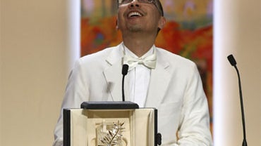 Director Apichatpong Weerasethakul receives the Palme d'Or award during the awards ceremony at the 63rd international film festival, in Cannes, southern France, Sunday, May 23, 2010. His film, "Uncle Boonmee Who Can Recall His Past Lives," won the top hon 
