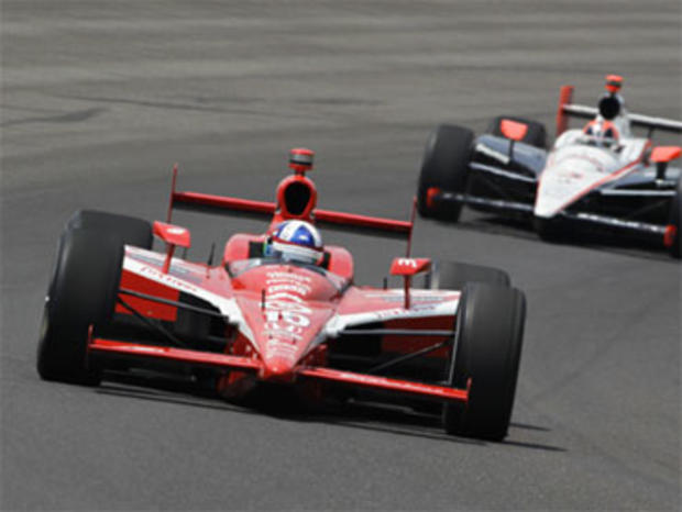 Dario Franchitti, of Scotland, leads Helio Castroneves, of Brazil, early in the race during the Indianapolis 500 auto race at the Indianapolis Motor Speedway in Indianapolis, Sunday, May 30, 2010. 