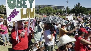 Hundreds gathered at a rally supporting Arizona's new law on illegal immigration as they listen to speakers near the capitol Saturday, June 5, 2010, in Phoenix. (AP Photo/Ross D. Franklin)  