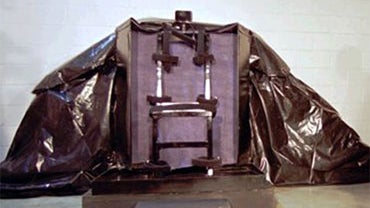 In this Jan. 24, 1996, file photo, reporters look at the chair where John Albert Taylor will be strapped to during a media tour of the firing-squad execution chamber in Utah State Prison at Point of the Mountain, Utah. Ronnie Lee Gardner, a 49-year-old co 