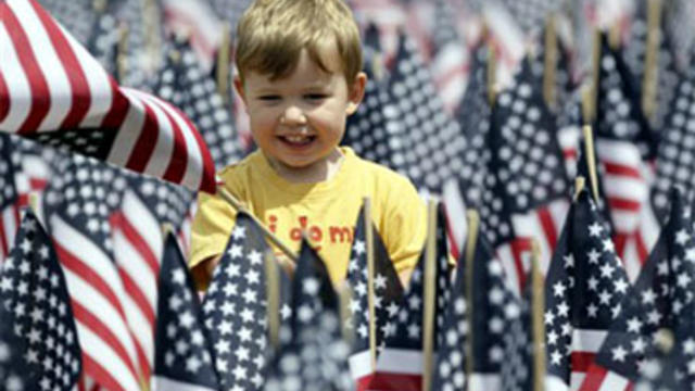 Cameron Geiselman, 2, of Springfield, Va., plays in a sea of flags on the National Mall in Washington, Wednesday, June 30, 2010, placed by The Sierra Club, veterans, unions, and conservationist to call for freedom from oil. (AP Photo/Carolyn Kaster)   gen 