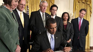 President Barack Obama signs the Iran Sanctions Bill imposing tough new sanctions against Iran as further punishment for the country's continuing ambitions to become a nuclear power, Thursday, July 1, 2010, in the East Room of the White House in Washingto 