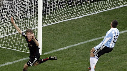 Germany's Thomas Mueller, left, celebrates after scoring the opening goal during the World Cup quarterfinal soccer match between Argentina and Germany at the Green Point stadium in Cape Town, South Africa, Saturday, July 3, 2010.  