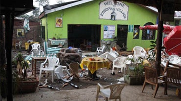 Damaged chairs and tables amongst the debris strewn outside the restaurant "Ethiopian village" in Kampala, Uganda, Monday, July 12, 2010 after an explosion at the restaurant late Sunday. 