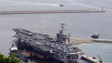 The U.S. nuclear-powered aircraft carrier USS George Washington drops anchor at the Busan port in Busan, south of Seoul, South Korea, Saturday, July 24, 2010. (AP Photo/Lee Jin-man) 