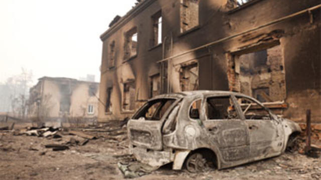 A charred car stands in the village of Mokhovoe destroyed by a forest fire near the town of Lukhovitsy some 84 miles southeast of Moscow, Friday, July 30, 2010. 
