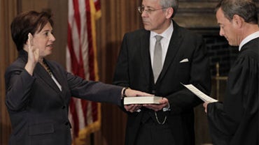 Elena Kagan is sworn in as the Supreme Court's newest member as Chief Justice John Roberts, right, administers the judicial oath, at the Supreme Court Building in Washington, Saturday, Aug. 7, 2010. The Bible is held by Jeffrey Minear, center, counselor t 