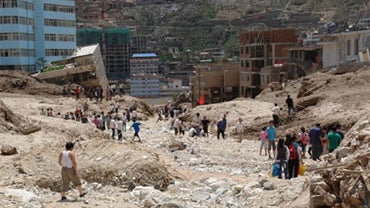 Rubble-strewn floodwaters tore through a remote corner of northwestern China on Sunday, Aug. 8, 2010, smashing buildings, overturning cars and killing at least 127 people.  