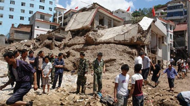 Residents salvage belongings from their damaged homes in Zhouqu, northwest China's Gansu province on August 8, 2010, after a deadly flood-triggered landslide. 