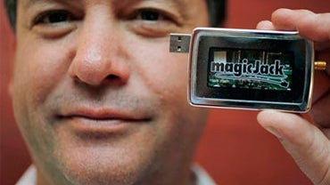 In this file photograph taken Jan. 7, 2010, magicJack CEO and founder Dan Borislow holds up the new and improved magicJack at the Consumer Electronics Show (CES) in Las Vegas.(AP Photo/Paul Sakuma) 