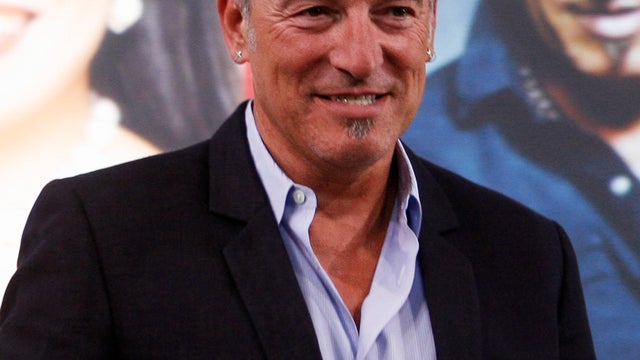 FILE - In this April 22, 2010 file photo, singer Bruce Springsteen stands on stage after being honored at the Ellis Island Family Heritage Awards in New York. (AP Photo/Jason DeCrow, file) 