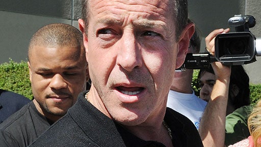 Michael Lohan, the father of Lindsay Lohan, leaves the building after she was sentenced to 90 days jail by Judge Marsha Revel during her hearing at the Beverly Hills Courthouse on July 6, 2010. 