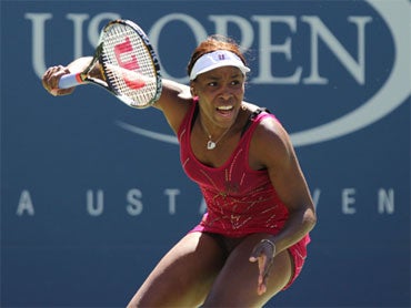 Venus Williams of the United States returns a shot against Shahar Peer of Israel during her women's singles match on day seven of the 2010 U.S. Open. 