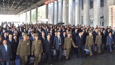 delegates to the ruling Worker's Party meeting make their way upon arriving at Pyongyang station, North Korea 