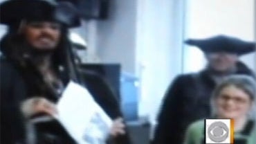 Actor Johnny Depp with Bea Delap during Delap's surprise visit from the star at her London school. 