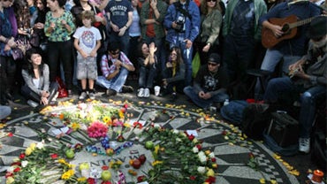 People sing as they gather around the Imagine mosaic in Strawberry Fields in New York's Central Park, Saturday, Oct. 9, 2010, the day that would have been John Lennon's 70th birthday. 