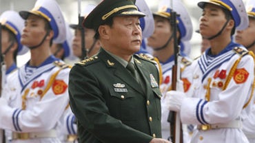 Chinese Defense Minister Liang Guanglie reviews the guard of honor during welcoming ceremony at the National Convention Center before the first Association of Southeast Asian Nations (ASEAN) Defense Ministers' Meeting Plus (ADMM Plus) in Hanoi, Vietnam Tu 