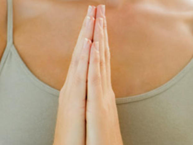 Two young girls meditating with hands joined 