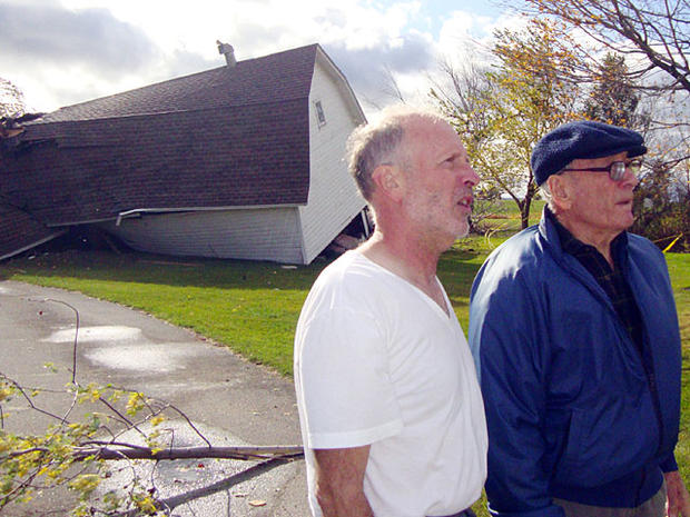 Bob Miller, left, and his father Norm inspect the damage to Normâ 