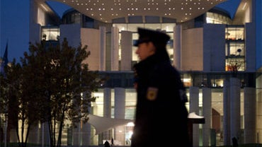 Police are seen Tuesday, Nov. 2, 2010 in Berlin outside the Chancellor's Office, where a suspicious parcel has been secured. 
