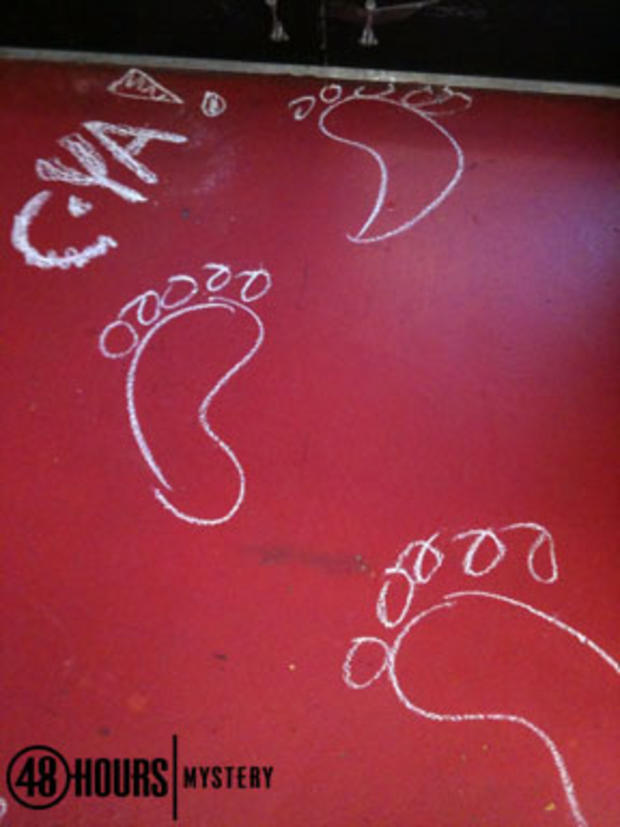 Close-up-of-chalk-footprints-on-red-floor.jpg 