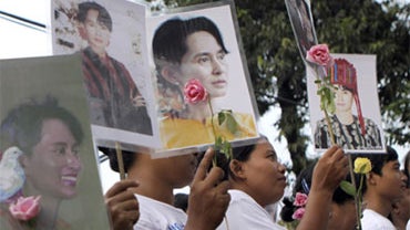 Supporters of Myanmar's pro-democracy leader Aung San Suu Kyi hold portraits their detained leader at her National League for Democracy (NLD) headquarters in Yangon, Myanmar, Friday, Nov. 12, 2010. 