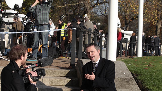 Members of the media work on the story of Britain's Prince William engagement, across the street from Buckingham Palace in central London, Tuesday, Nov. 16, 2010. Britain's  