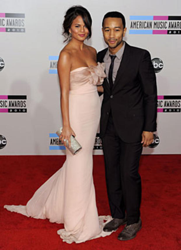 John Legend, right, and Christine Teigen arrive at the 38th Annual American Music Awards on Sunday, Nov. 21, 2010 in Los Angeles. (AP Photo/Chris Pizzello) 