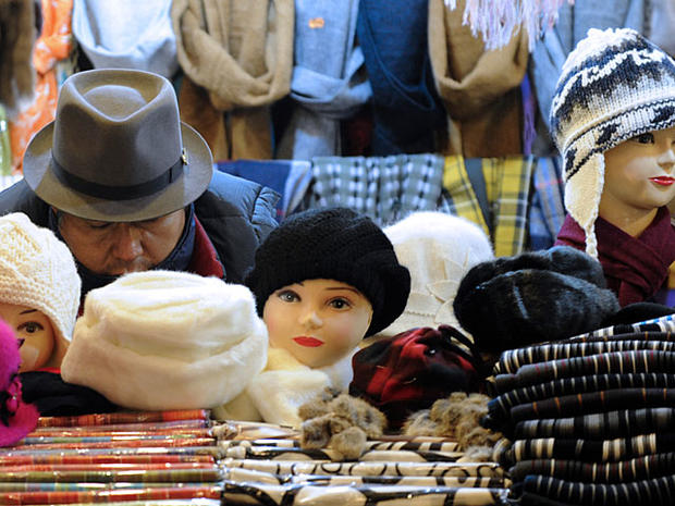 vendor sleeps in his stand of scarfs and hats at the christmas market on November 22 2010 in Metz, eastern France. AFP PHOTO / JEAN-CHRISTOPHE VERHAEGEN (Photo credit should read JEAN-CHRISTOPHE VERHAEGEN/AFP/Getty Images) 