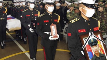 South Korean marines carry a portrait and casket containing the remains of Sgt. Seo Jeong-woo, a South Korean marine killed in Tuesday's North Korean bombardment, during a funeral service at a military hospital in Seongnam, South Korea, Saturday, Nov. 27, 
